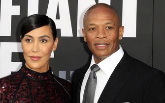 epaselect epa06044823 US producer Andre Young aka Dr Dre arrives with his wife Nicole Young (L) for the HBO premiere of the miniseries 'The Defiant Ones' at the Paramount Theater at Paramount Studios in Los Angeles, California, USA, 22 June 2017. The show debuts in the US 09 July 2017.  EPA/NINA PROMMER