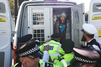 TOPSHOT - Swedish climate activist Greta Thunberg stands inside a police van after being arrested outside the InterContinental London Park Lane during the "Oily Money Out" demonstration organised by Fossil Free London and Greenpeace on the sidelines of the opening day of the Energy Intelligence Forum 2023 in London on October 17, 2023. (Photo by HENRY NICHOLLS / AFP) (Photo by HENRY NICHOLLS/AFP via Getty Images)