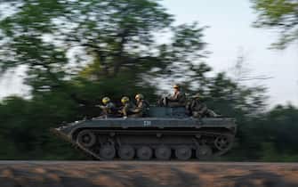 TOPSHOT - Ukrainian soldiers ride on a BMP infantry fighting vehicle toward Bakhmut, on May 20, 2023, amid the Russian invasion of Ukraine. Ukraine on May 20, 2023, said it retained some ground control in the eastern city of Bakhmut, which Russia's Wagner group claimed to have captured, with fighting ongoing and the situation "critical". (Photo by Sergey SHESTAK / AFP) (Photo by SERGEY SHESTAK/AFP via Getty Images)