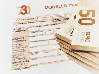 Province of Florence , January 14th 2024, many euro banknotes with the “Modello 730” as background , translating in Italian as declaration of incomes