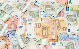 Pile of money euro banknotes as wallpaper or background. Euro paper money.