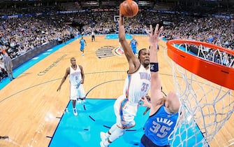 OKLAHOMA CITY, OK - DECEMBER 27: Kevin Durant #35 of the Oklahoma City Thunder rises for a dunk against Chris Kaman #35 of the Dallas Mavericks on December 27, 2012 at the Chesapeake Energy Arena in Oklahoma City, Oklahoma. NOTE TO USER: User expressly acknowledges and agrees that, by downloading and or using this photograph, user is consenting to the terms and conditions of the Getty Images License Agreement. Mandatory Copyright Notice: Copyright 2012 NBAE (Photo by Layne Murdoch/NBAE via Getty Images)