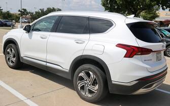 epa10886490 A general view of a Hyundai Santa Fe in Austin, Texas, USA, 27 September 2023. Kia and Hyundai have recalled nearly 3.4 million cars due to fire risk and encourage owners to keep cars parked outside. Hyundai's Santa Fe is on the list of recalled cars.  EPA/ADAM DAVIS