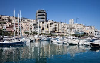 Principality of Monaco skyline from Port Hercule, harbor in the Mediterranean Sea bay on French Riviera, southern Europe.