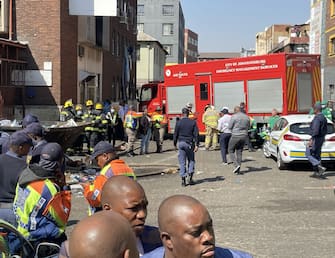 JOHANNESBURG, SOUTH AFRICA - AUGUST 31: Firefighters and healthcare professionals are deployed at the scene after fire at a five-story building in South Africa's Johannesburg city on August 31, 2023. At least 63 people were killed in the fire. The five-story building is reported to be abandoned and people were allegedly living in illegally. (Photo by Murat Ozgur Guvendik/Anadolu Agency via Getty Images)
