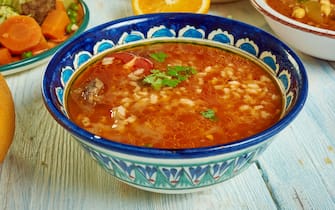 zuppe Chorba Frik - traditional soup, Algerian cuisine, Traditional assorted Mediterranean dishes, Top view.