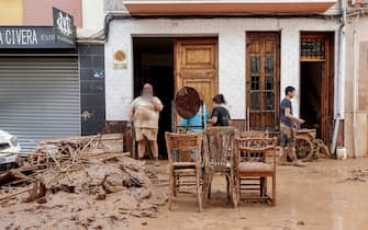 epaselect epa11692859 Residents salvage furniture in the flood-hit municipality of Paiporta, in the province of Valencia, Spain, 30 October 2024. The intense rainfall impacting the eastern part of the country resulted in at least 70 lives being lost in the province of Valencia and neighboring provinces due to the flooding. The State Meteorological Agency (AEMET) issued orange and red alerts for rainfall in multiple regions of east and southern Spain due to a DANA (isolated depression at high levels) phenomenon. The mayor of Paiporta, located about ten kilometers southwest of Valencia, confirmed that at least 34 people died in the municipality due to the flooding.  EPA/MANUEL BRUQUE