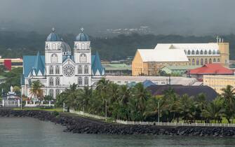 Arcadia's rainy arrival at Apia in Samoa. The Immaculate Conception Cathedral and the Samoan Cultural Village