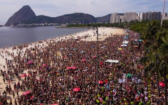 epa10475273 An aerial photo made with a drone shows revelers and members of the street troupe Amigos da Onca during a carnival parade at Flamengo beach in Rio de Janeiro, Brazil, 18 February 2023. Some 46 million people are expected to take part in Brazil's carnival celebration throughout the country, including thousands of foreign tourists, as well as generate income of some 1,558 million US dollars in the next five days.  EPA/ANDRE COELHO