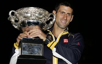 epa03558485 Novak Djokovic of Serbia poses with the trophy during a photocall after winning the men's final against Andy Murray of Great Britain at the Australian Open Grand Slam tennis tournament in Melbourne, Australia, 28 January 2013.  EPA/Dennis Sabangan