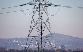 GLASTONBURY, UNITED KINGDOM - FEBRUARY 05: Electrical pylons carry electricity cables across fields on February 05, 2023 near Glastonbury, England. The UK government has published documents with plans for Britain should it have to go â  lights outâ   this winter after the National Grid warned there could be blackouts due to the ongoing energy crisis. There are fears that Russian President Vladimir Putin will restrict gas supplies to Europe and although the UK does not rely on Russian energy supply, it does import from electricity and gas from European countries that do. With many consumers already facing a cost of living crisis with sharp rises in their home energy bills, energy black outs look set to compound their misery this winter. (Photo by Matt Cardy/Getty Images)