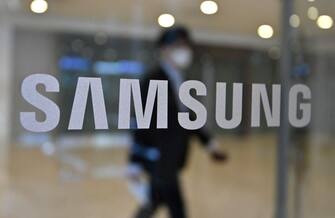 A man walks past the Samsung logo displayed on a glass door at the company's Seocho building in Seoul on April 28, 2021. (Photo by Jung Yeon-je / AFP) (Photo by JUNG YEON-JE/AFP via Getty Images)