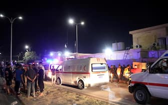 epa10885156 Iraqis gather outside a local hospital after a fire that broke out at a wedding hall in Hamdaniya, in Iraq's Nineveh province, north of Iraq, 27 September 2023. More than 100 people died and at least 150 are injured after a fire during a Christian wedding celebration in Iraq's Nineveh province.  EPA/MOHAMAD SAIF