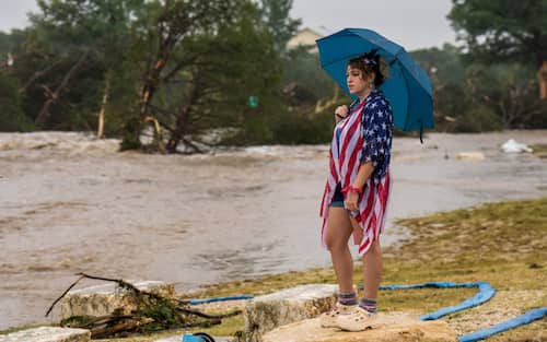 KERRVILLE, TEXAS - JULY 04: Kerrville resident Leighton Sterling watches flood waters along the Guadalupe River on July 4, 2025 in Kerrville, Texas. Heavy rainfall caused flooding along the Guadalupe River in central Texas with multiple fatalities reported. (Photo by Eric Vryn/Getty Images)