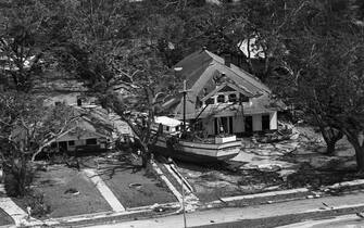 (Original Caption) 8/18/1969- Biloxi, MS-The Shrimper "Wade Klien" rests against a house that fronts the beach 8/18 where it was deposited by hurricane Camille.
