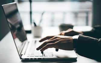 Man working online at home on his laptop computer.