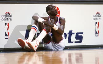 LANDOVER, MD - CIRCA 1986:  Manute Bol #10 of the Washington Bullets sits on the floor waiting to enter an NBA basketball game circa 1986 at the Capital Centre in Landover, Maryland. Bol played for the Bullets from 1985-88. (Photo by Focus on Sport/Getty Images) *** Local Caption *** Manute Bol