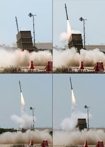 (COMBO) This combination of pictures shows an Israeli Iron Dome air defence system launching a missile to intercept rockets fired from the Gaza Strip, on the outskirts of the southern Israeli city of Ashkelon, on August 7, 2022, amid heightened tensions between Israel and Palestinian militants in the Gaza Strip. - Air raid sirens sounded in the Jerusalem area today, the Israeli army said, as militants in the Gaza Strip continued to trade fire with Israel for a third day. (Photo by JACK GUEZ / AFP) (Photo by JACK GUEZ/AFP via Getty Images)