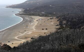 epa10767805 A general view shows a burnt area in the village of de Oeud Das in Bejaia east of Algiers, Algeria, 25 July 2023.  The Algerian Ministry of the Interior announced at least 34 people died, including 24 civilians and 10 members of the National Army and 26 people are injured in multiple forest fires across the country.  EPA/STR