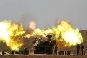 epa10912954 An Israeli artillery unit fires towards Gaza along the border in southern Israel, 11 October 2023. More than 1,200 Israelis have been killed and over 2,800 others injured, according to the Israel Defense Forces (IDF), after the Islamist movement Hamas launched an attack against Israel from the Gaza Strip on 07 October. More than 3,000 people, including 1,500 militants from Hamas, have been killed and thousands injured in both Gaza and Israel since the conflict erupted, according to Israeli military sources and Palestinian officials.  EPA/ATEF SAFADI