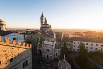 High angle view over the Saint Mary Major (Santa Maria Maggiore) Basilica and Colleoni Chapel in Upper Town (CittÃ  Alta) at sunset.