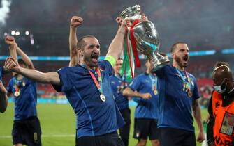 Italy's Giorgio Chiellini and Leonardo Bonucci carry the trophy and celebrate with team-mates after winning the penalty shoot-out after the UEFA Euro 2020 Final at Wembley Stadium, London. Picture date: Sunday July 11, 2021.  PA Photo. See PA story SOCCER England. Photo credit should read: Nick Potts/PA Wire.RESTRICTIONS: Use subject to restrictions. Editorial use only, no commercial use without prior consent from rights holder.