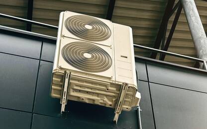 Industrial air conditioning units mounted on a modern glass and steel building