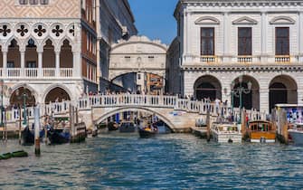 City of Venice in Italy. Bridge of Sighs behind Ponte della Paglia bridge, Doge Palace and Palazzo delle Prigioni Nove, view from the Venetian Lagoon.