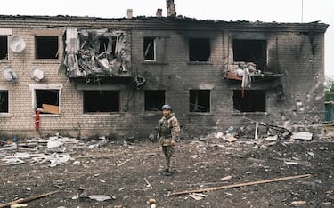 epa11336743 A Ukrainian police officer inspects a damaged building during the evacuation of local people from territories bordering Russia, in the city of Vovchansk, Kharkiv region, northeastern Ukraine, 13 May 2024, amid the Russian invasion. More than 4,000 residents from settlements in areas of the Kharkiv region bordering Russia have been evacuated as 'hostilities intensified', the head of the Kharkiv Military Administration Oleg Synegubov wrote on telegram. The evacuations follow a cross-border offensive by Russian forces, who claimed the capture of several villages in the region. Russian troops entered Ukrainian territory on 24 February 2022, starting a conflict that has provoked destruction and a humanitarian crisis.  EPA/GEORGE IVANCHENKO