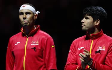 epaselect epa11729466 Rafael Nadal (L) and Carlos Alcaraz of Spain observed a minute of silence in memory of the victims of the floods in Valencia, moments before starting the Davis Cup semi-final between Netherlands and Spain at the Jose Maria Martin Carpena Sports Palace in Malaga, Spain, 19 November 2024.  EPA/Jorge Zapata