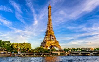 Paris Eiffel Tower and river Seine at sunset in Paris, France. Eiffel Tower is one of the most iconic landmarks of Paris.