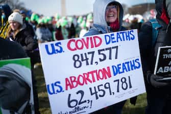Washington, DC - January 21: Melanie Frei, 66, of Tomah Wisconsin holds a sign comparing covid deaths to abortion deaths. She says she is a civil rights activist for the unborn.
The March for Life Rally was held on the National Mall on Friday, January 21, 2022. The group then marched up Constitution Ave. to the steps of the U.S. Supreme Court. (Photo by Sarah L. Voisin/The Washington Post via Getty Images)