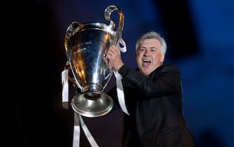 MADRID, SPAIN - MAY 25: Head coach Carlo Ancelotti of Real Madrid CF holds the UEFA Champions League cup celebrating their victory on the UEFA Champions League Final match against Club Atletico de Madrid at Cibeles square on the early morning of May, 25, 2014 in Madrid, Spain. Real Madrid CF achieves their 10th European Cup at Lisbon 12 years later.  (Photo by Gonzalo Arroyo Moreno/Getty Images)