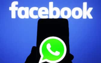 In this photo illustration a WhatsApp logo seen on a smartphone screen and the Facebook logo in the background.
In January 2021, WhatsApp announced a new Privacy Policy that will allow WhatsApp to share data with Facebook, and users will be to accept the new policy by 8 February 2021, or stop using the app, reportedly by media. (Photo by Pavlo Gonchar / SOPA Images/Sipa USA)
