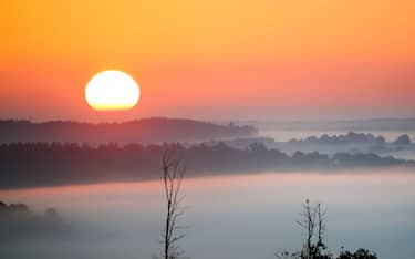03 October 2022, Baden-Wuerttemberg, Uttenweiler: The sun rises in the morning, while dense fog has formed over Upper Swabia. Photo: Thomas Warnack/dpa (Photo by Thomas Warnack/picture alliance via Getty Images)