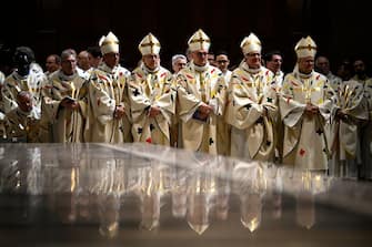 Members of the clergy attend the first mass for the public in which Archbishop of Paris will lead prayers to consecrate the new main alter, at the Notre-Dame de Paris cathedral, in Paris, on December 8, 2024. Newly restored Notre Dame cathedral is set to hold its first service for the public on December 8, 2024 after a historic re-opening ceremony that saw firefighters, builders and artists celebrated for their work saving the 12th-century masterpiece. The beloved Paris monument nearly burned down in 2019, but has been renovated inside and fitted with a new roof and spire during a frenzied reconstruction effort since then. (Photo by JULIEN DE ROSA / AFP) (Photo by JULIEN DE ROSA/AFP via Getty Images)