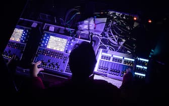 27 March 2021, Berlin: A person operates a mixing console at a test concert entitled "Operation Heartbeat" in the "SÃ¤Ã¤lchen" on the Holzmarkt. All event participants took a Corona quick test in advance. The project aims to test the logistical feasibility of events in conjunction with Sars-CoV-2 antigen testing in order to develop feasible scenarios for the reopening of the culture. Photo: Christoph Soeder/dpa