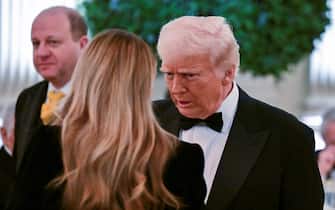 US President Donald Trump speaks with First Lady Melania Trump during the National Governors Association Evening Dinner and Reception in the East Room of the White House in Washington, DC, on February 22, 2025. (Photo by ROBERTO SCHMIDT / AFP)