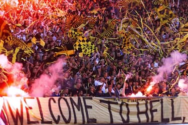 STOCKHOLM, SWEDEN - AUGUST 26:  AIK Solna fans display a banner reading "Welcome To Hell" as they wave flags and cheer in the stands of Rasunda stadium in Stockholm during the Champions League third qualifying, second leg match between AEK Solna and AEK Athens, 25 August 1999.  (Photo credit should read GUNNAR SEIJBOLD/AFP via Getty Images)