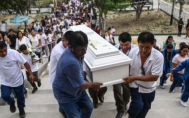 Relatives of 10-year-old Fer Maria Ancajima, who died from dengue fever, carry her coffin before her burial at a graveyard in Catacaos district, Piura department, Peru on June 10, 2023. (Photo by Ernesto BENAVIDES / AFP) (Photo by ERNESTO BENAVIDES/AFP via Getty Images)