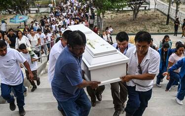 Relatives of 10-year-old Fer Maria Ancajima, who died from dengue fever, carry her coffin before her burial at a graveyard in Catacaos district, Piura department, Peru on June 10, 2023. (Photo by Ernesto BENAVIDES / AFP) (Photo by ERNESTO BENAVIDES/AFP via Getty Images)