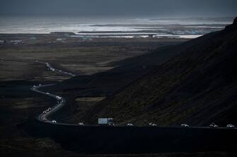 This photo taken on November 13, 2023 shows vehicles leaving the town of Grindavik, southwestern Iceland, during evacuation following earthquakes. The southwestern town of Grindavik -- home to around 4,000 people -- was evacuated in the early hours of November 11 after magma shifting under the Earth's crust caused hundreds of earthquakes in what experts warned could be a precursor to a volcanic eruption.  The seismic activity damaged roads and buildings in the town situated 40 kilometres (25 miles) southwest of the capital Reykjavik, an AFP journalist saw. (Photo by Kjartan TORBJOERNSSON / AFP) / Iceland OUT (Photo by KJARTAN TORBJOERNSSON/AFP via Getty Images)