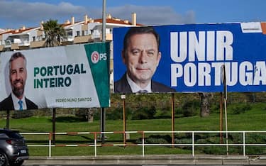 SAO PEDRO DO ESTORIL, PORTUGAL - JANUARY 20: A Socialist Party billboard campaign poster with a picture of its leader Pedro Nuno Santos and a PSD campaign poster with the face of Luis Montenegro displayed in Sao Pedro do Estoril roundabout for the Portuguese early legislative elections to be held on March 10, 2024, on January 20, 2024, in Sao Pedro do Estoril, Portugal. The leaders of the governmental Socialist Party, Pedro Nuno Santos, and the main opposition Social Democratic Party, Luis Montenegro, will lead their parties for the first time in this occasion. The Portuguese crisis began on November 7, 2023, when the Public Prosecutor's Office ordered a search that included the Prime Minister's office, the Ministry of the Environment and Climate Action and the Ministry of Infrastructure, while investigating active and passive corruption and prevarication in relation to concessions for lithium mining in northern Portugal, a project for a green hydrogen production plant and a project for a data center. This led to the resignation of Antonio Costa and the fall of Portugal's XXIII Constitutional Government. President Marcelo Rebelo de Sousa decreed the dissolution of parliament on January 15, previously announced on November 09, 2023, and the calling of early legislative elections. (Photo by Horacio Villalobos#Corbis/Corbis via Getty Images)