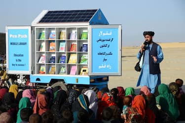 In this photograph taken on May 17, 2022, Matiullah Wesa, head of PenPath and advocate for girls' education in Afghanistan, speaks to children during a class next to his mobile library in Spin Boldak district of Kandahar Province. - Wesa, the founder of a project that campaigned for girls' education in Afghanistan, has been detained by Taliban authorities in Kabul, his brother and the United Nations said on March 28, 2023. (Photo by Sanaullah SEIAM / AFP) (Photo by SANAULLAH SEIAM/AFP via Getty Images)