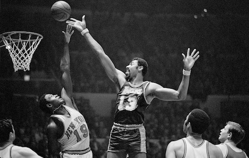 (Original Caption) Fingertips New York: Wilt Chamberlain (#13) of the Los Angeles Lakers and Willis Reed (#19) of the New York Knickerbockers go after a rebound during game at Madison Square Garden here Feb. 18th. Chamberlain scored 31 points to lead the Lakers to a 113-109 victory over the Knicks and crack the Knicks' 11-game winning streak.