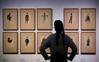 24 February 2023, Saxony-Anhalt, Halle (Saale): A participant in a preview of the exhibition "The Other Picasso: Back to the Origins. Ceramic Works and Works on Paper" stands in front of prints by Pablo Picasso with costume designs for the ballet "Le Tricorne" at the Kunstmuseum Moritzburg. On the occasion of the 50th anniversary of Picasso's death, the art museum is devoting itself to a little-known side of the artist. On display are 103 works from public and private collections in Spain. The show is one of the few to be held in Germany in this anniversary year. Photo: Hendrik Schmidt/dpa - ATTENTION: Only for editorial use in connection with current reporting and only in full format (Photo by Hendrik Schmidt/picture alliance via Getty Images)