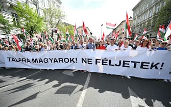 Led by Hungarian lawyer and former government insider Peter Magyar, the ex-husband of former Justice Minister Judit Varga, political opposition activists and their sympathizers participate in a march in downtown Budapest on April 6, 2024, to protest against corruption and the Hungarian government. The banner reads: 'Step up Hungarians! Do not be afraid!' (Photo by Attila KISBENEDEK / AFP)