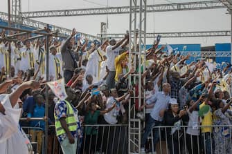 Attendees cheer while Pope Francis (not seen) arrives for the mass at the N'Dolo Airport in Kinshasa, Democratic Republic of Congo (DRC), on February 1, 2023. (Photo by Guerchom Ndebo / AFP) (Photo by GUERCHOM NDEBO/AFP via Getty Images)