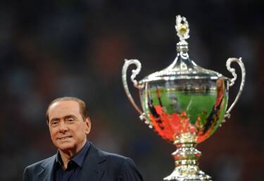 Italian President of Council Silvio Berlusconi stands near the Trophee Luigi Berlusconi after the match in which AC Milan beat Juventus 2-1,  on August 21, 2011, in San Siro stadium in Milan . AFP PHOTO / OLIVIER MORIN (Photo by Olivier MORIN / AFP) (Photo by OLIVIER MORIN/AFP via Getty Images)