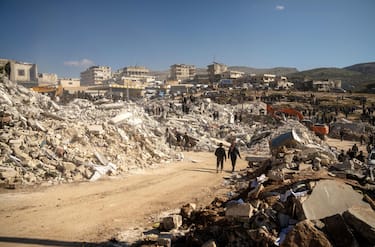 epa10455054 A general view over the rubble of collapsed houses, in Harim town near Idlib, Syria, 08 February 2023. More than 11,000 people have died and thousands more injured after two major earthquakes struck southern Turkey and northern Syria on 06 February. Authorities fear the death toll will keep climbing as rescuers look for survivors across the region.  EPA/KARAM AL-MASRI  EPA-EFE/KARAM AL-MASRI